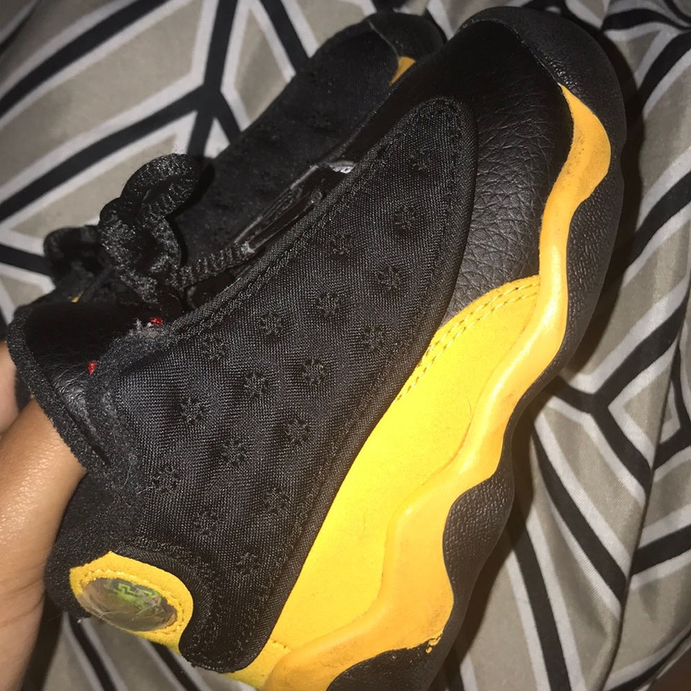 black and yellow Jordan 13